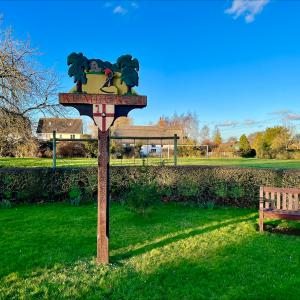 Village sign & pleasure Ground